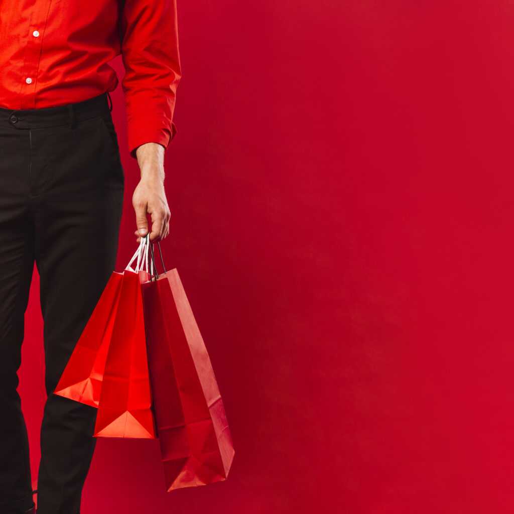 close-up-adult-man-holding-shopping-bags