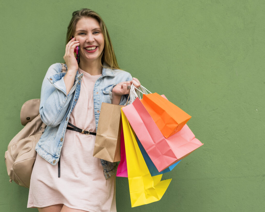 pretty-woman-with-bright-shopping-bags-talking-by-phone